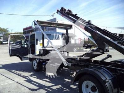 Isuzu NPRR truck with roll-off bed and hydraulic crane, cab doors open, side view showing equipment, used stock number T00964FM.