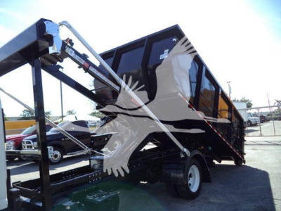 Isuzu NPR/RR dump truck in tilt bed view with hydraulic arms and black cargo bed.