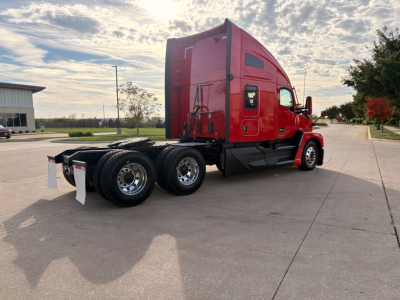 Kenworth T680 tractor, red cab, side view showing rear wheels and sleeper, with no visible text.