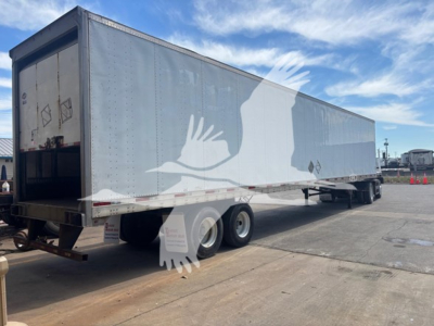 2018 Utility 4000D-X trailer in a parking lot showing side and rear with blue-gray exterior and dual rear wheels.