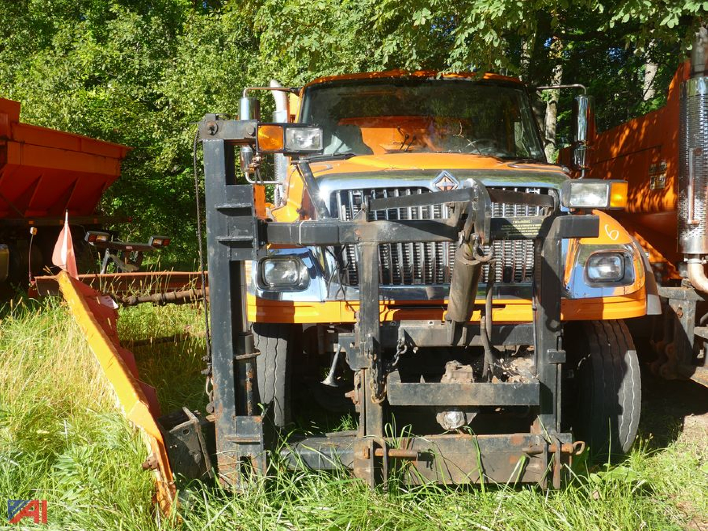 International 7600 Workstar front view with wing plow attachment and heavy-duty grille guard.