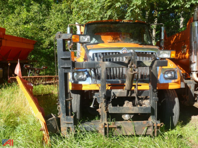 International 7600 Workstar front view with wing plow attachment and heavy-duty grille guard.