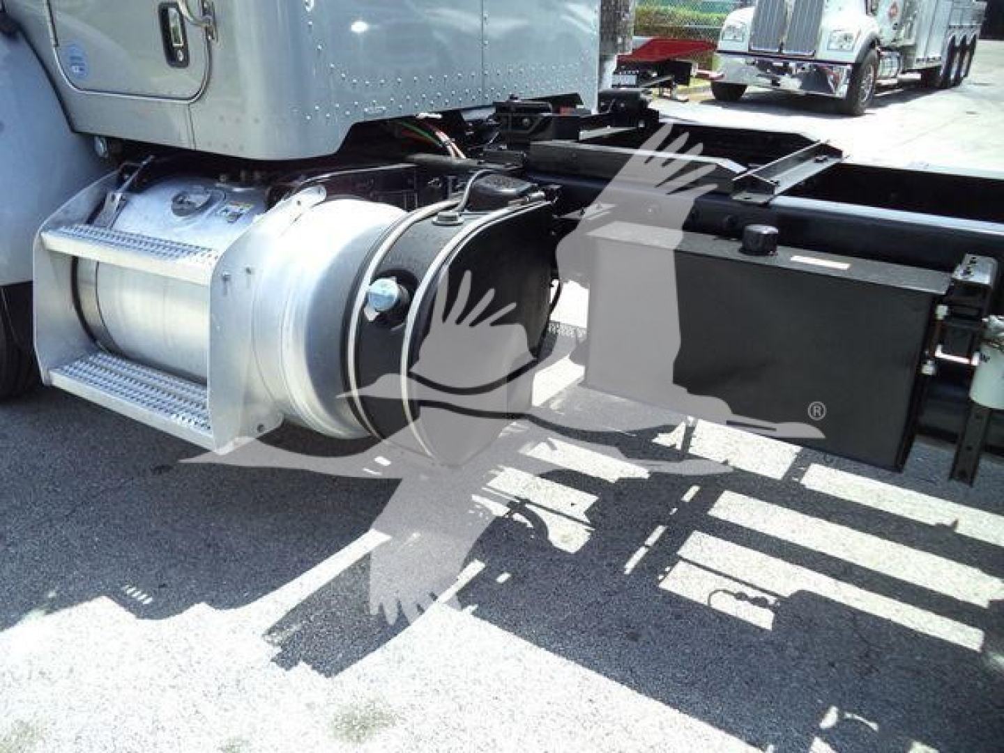 Peterbilt 348 rollback chassis showing fuel tank, steps, and side components.