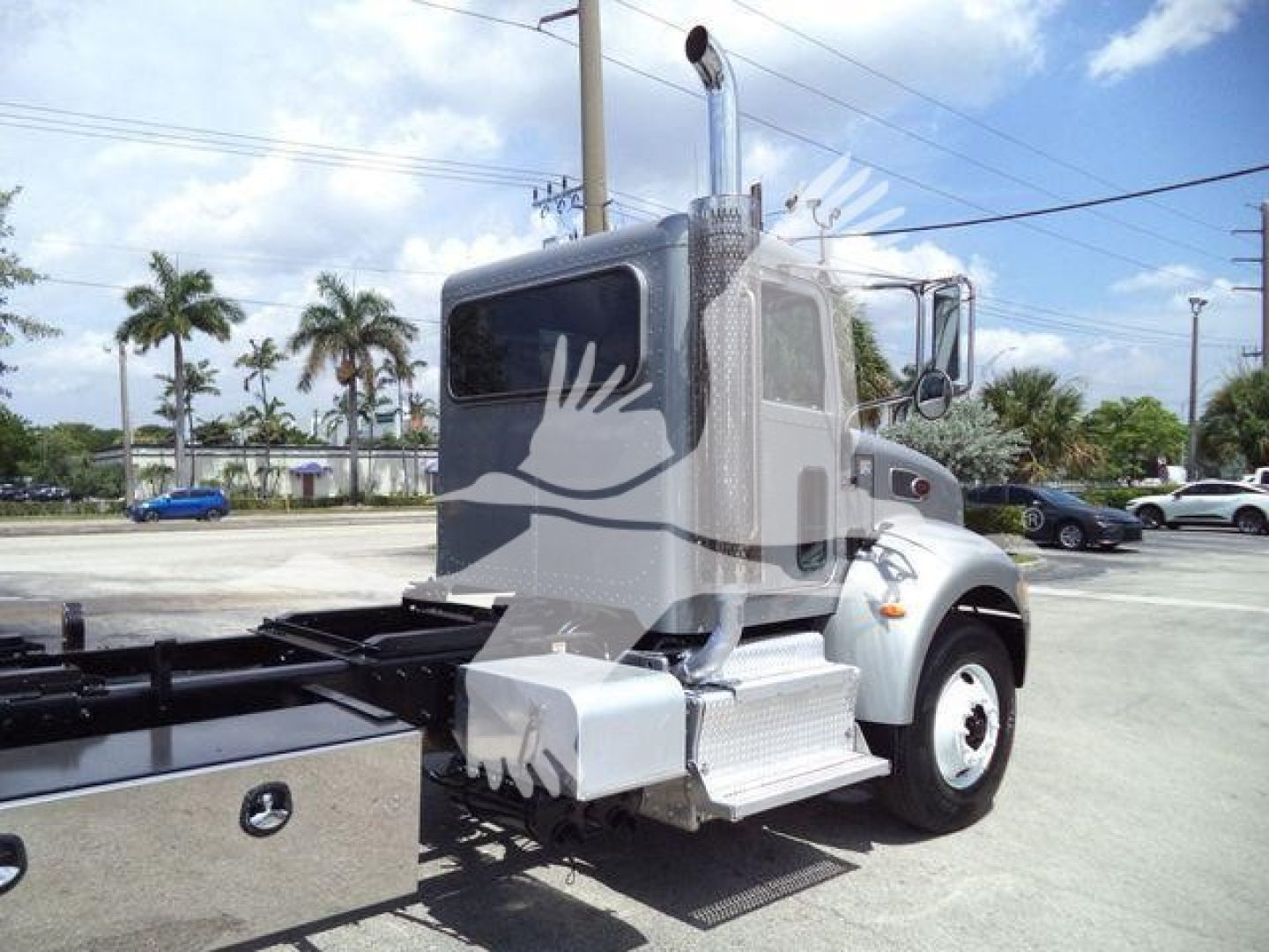 Peterbilt 348 cab and chassis in rollback service configuration, side view showing steps, fuel tank, exhaust stack, and front wheel; VIN and stock not visible on image.
