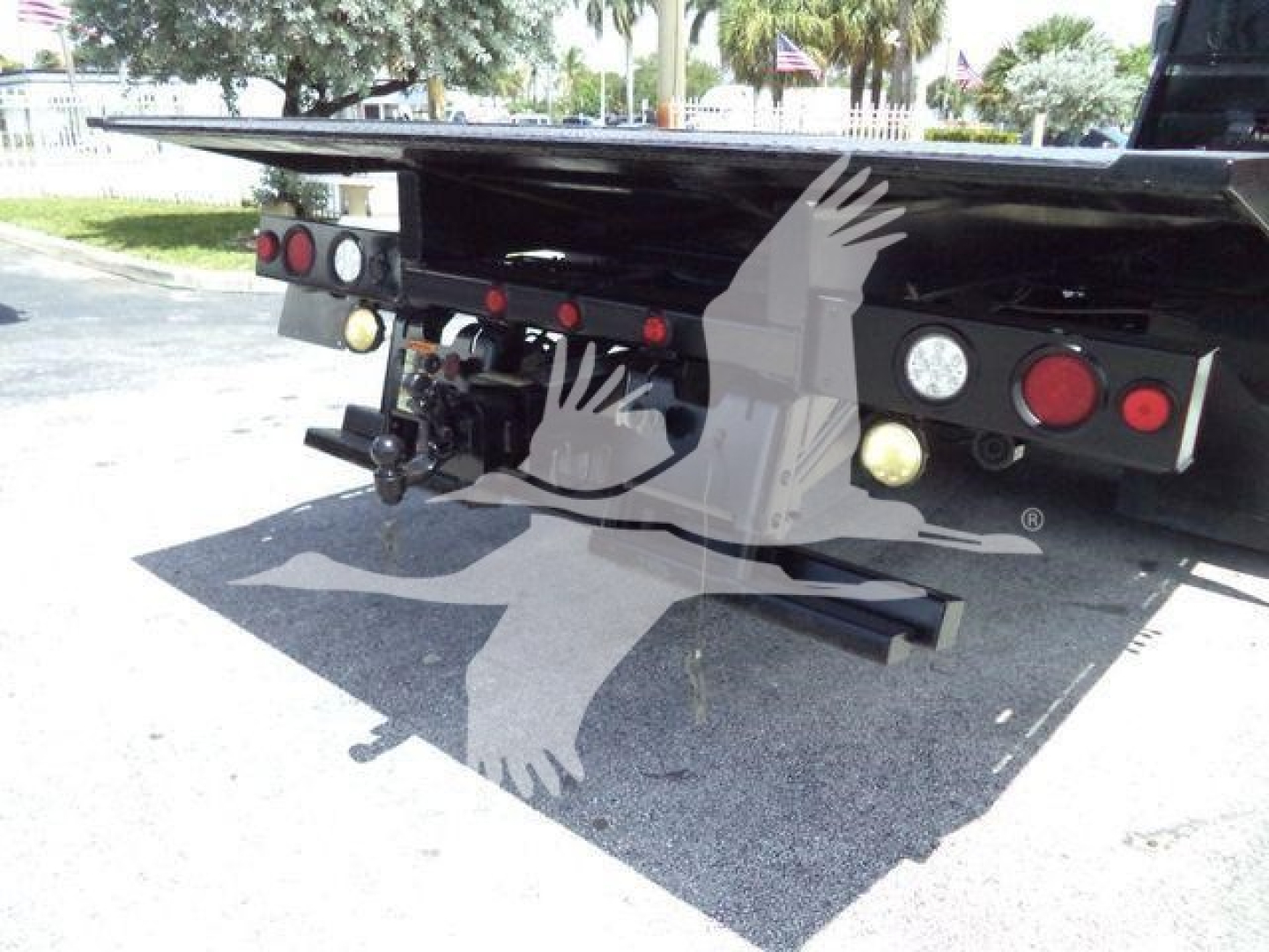 Peterbilt rollback truck rear view showing towing hitch, rear lights, and support structure under flatbed.
