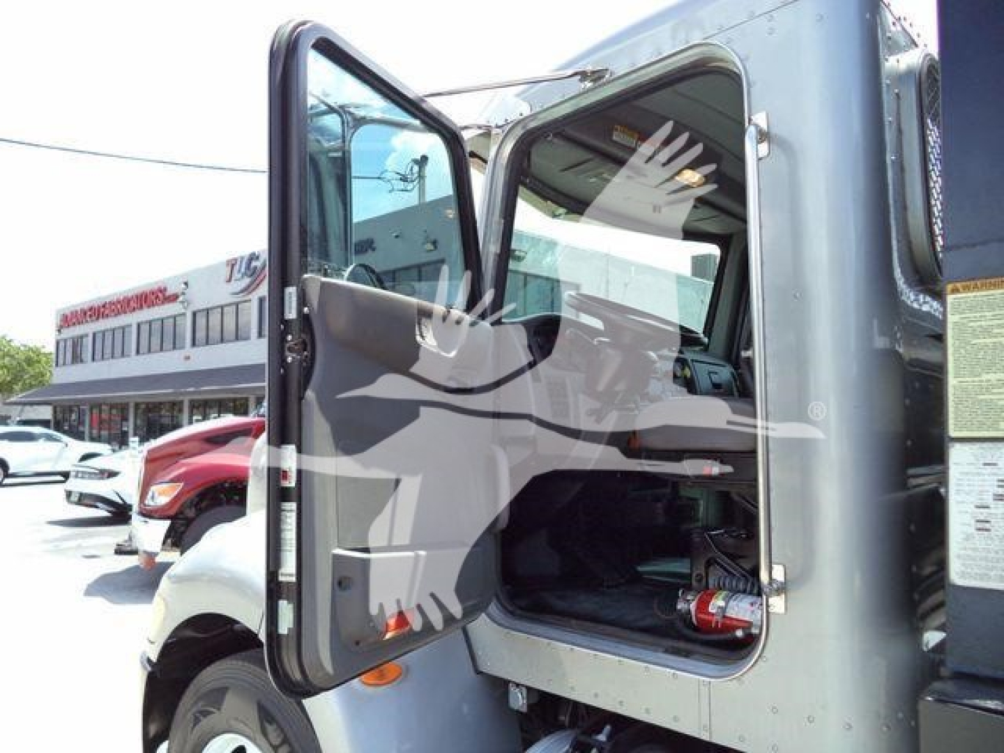 Truck cab door open of a 2015 Peterbilt 348 rollback truck showing the cab interior and door frame with a window, no text legible.