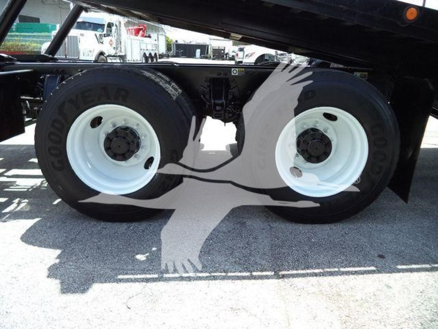 Peterbilt 348 rollback truck dual rear wheels showing Goodyear tires and white rims under a raised bed.