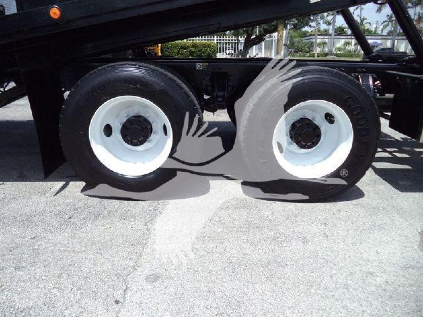 Peterbilt 348 rollback truck rear dual rear axle wheels and frame visible with white rims.