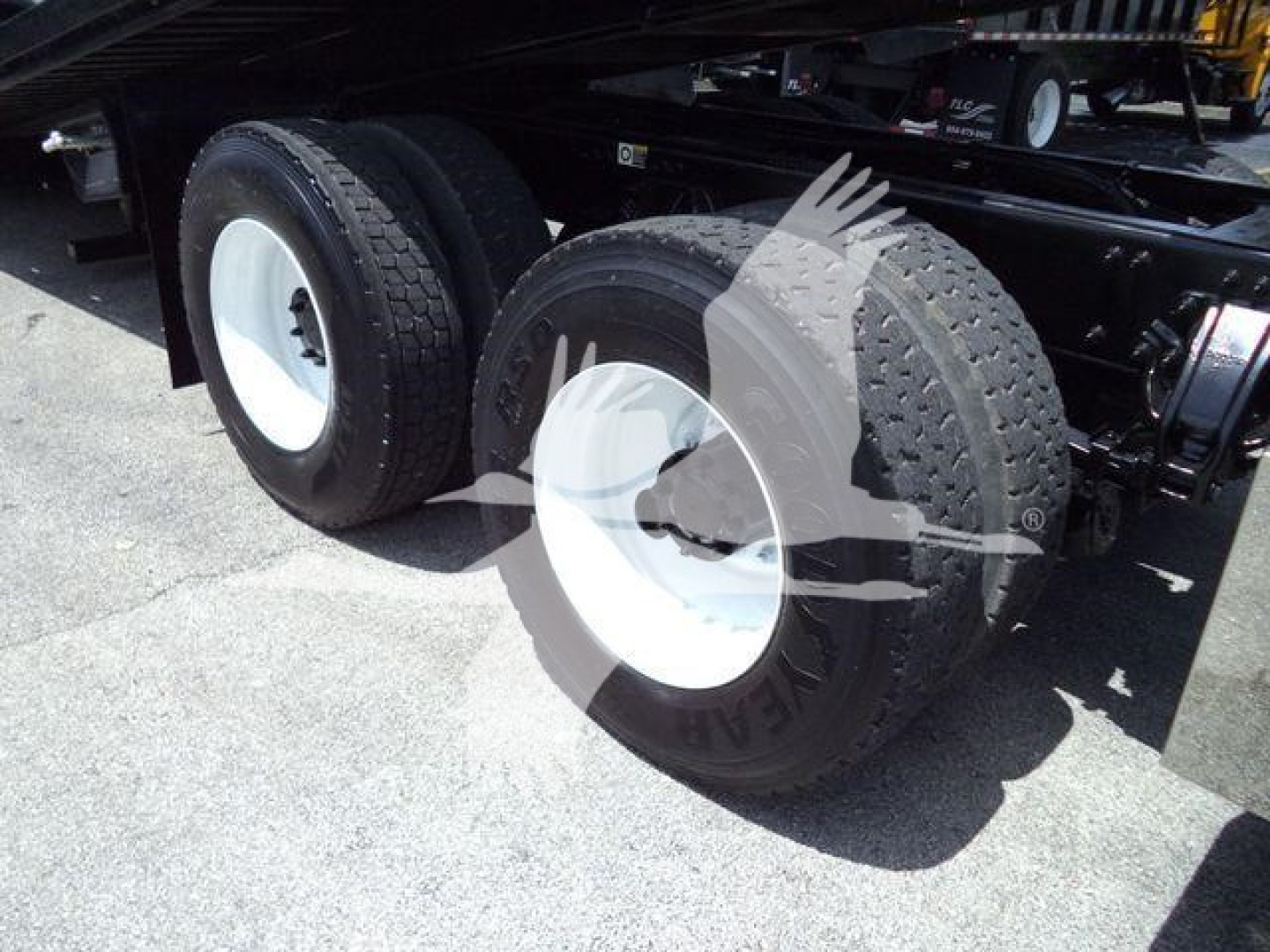 Peterbilt 348 rollback truck rear dual wheels with white rims and tires, undercarriage and frame visible.