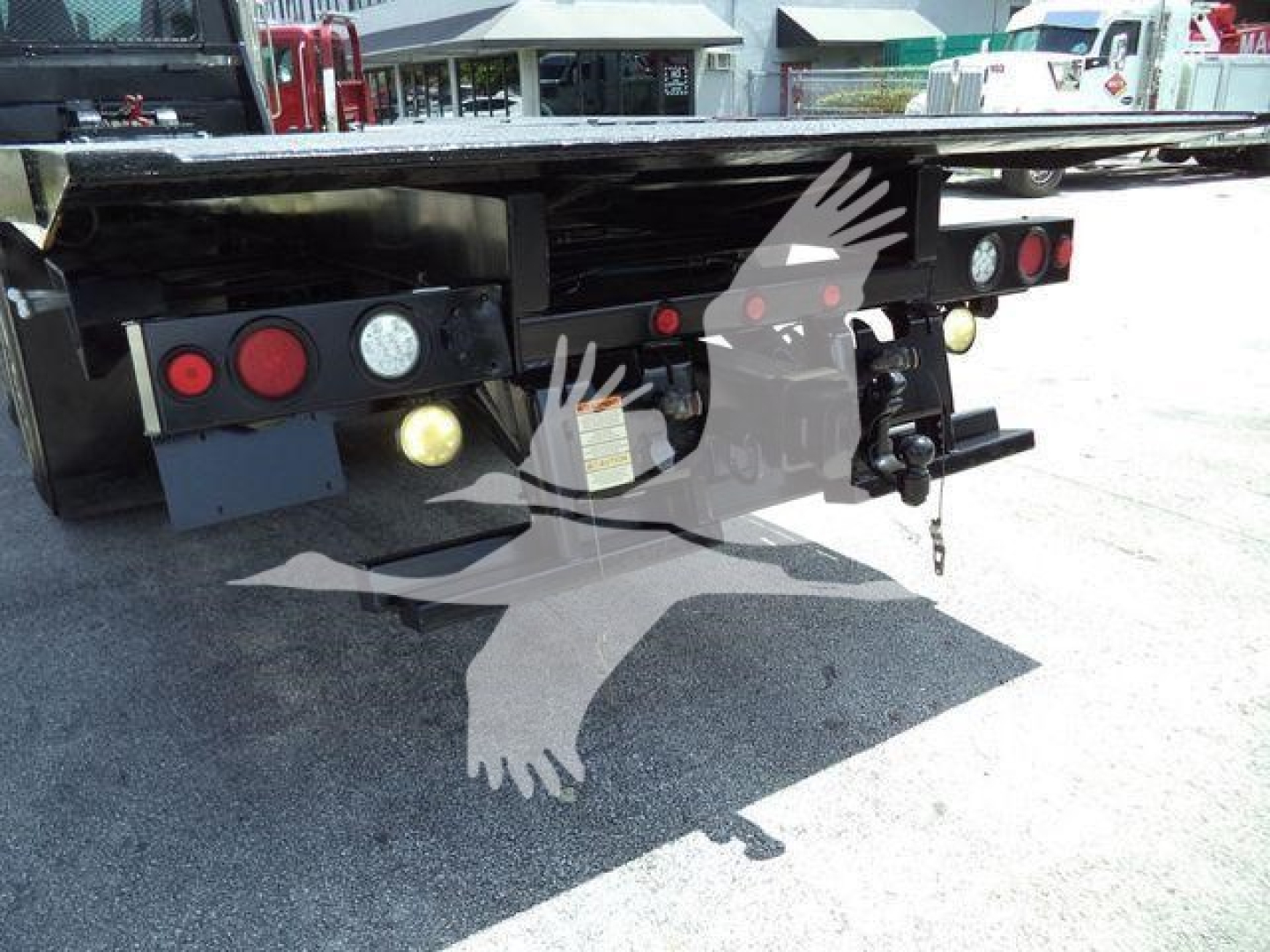 Peterbilt rollback truck rear showing taillights, hitch, and underside components.
