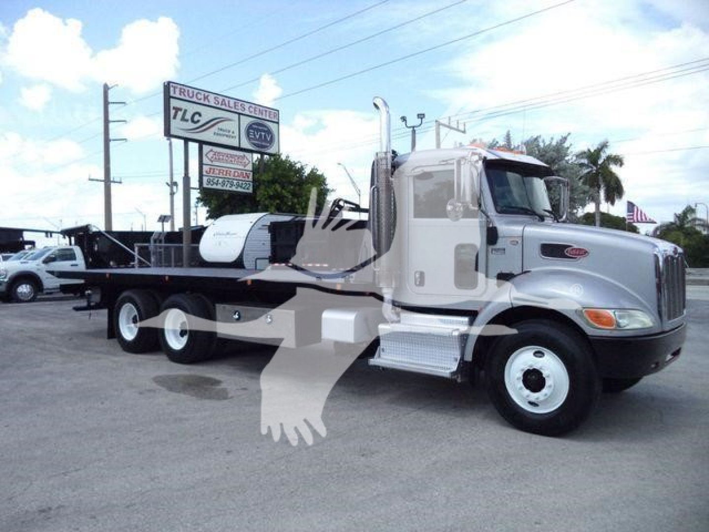 Peterbilt 348 rollback tow truck side view showing chassis and cab with fuel tanks and steps.