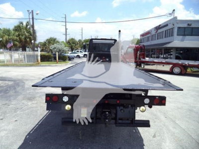 Truck bed of a Peterbilt rollback showing flatbed and rear lights.