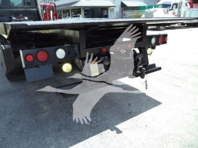 Peterbilt rollback truck rear showing taillights, hitch, and underside components.