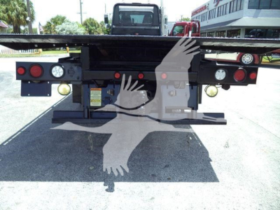Peterbilt 348 rollback rear view showing taillights, bumper, and hydraulic equipment mounting points.