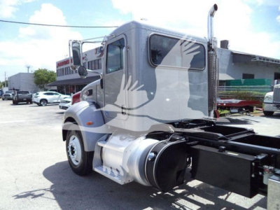 Peterbilt 348 rollback truck cab and chassis side view showing fuel tank, dual mirror, and rear undercarriage with drive shafts and frame.