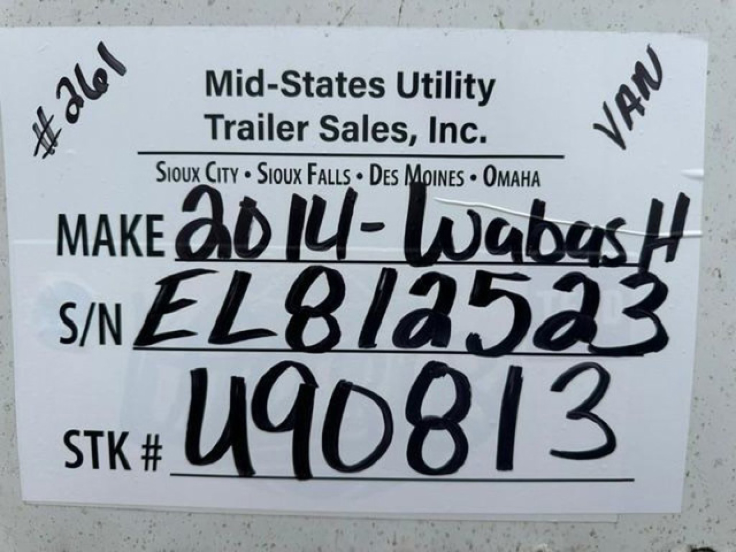Trailer tag with handwritten VIN, stock number, and make information on a Wabash trailer. Text: Mid-States Utility Trailer Sales, Inc. Make 2014-Wabash; S/N EL812523; STK # 490813; S/O numbers handwritten.
