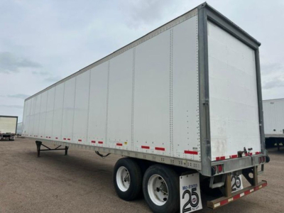 Two-axle white Wabash van trailer with rear doors and left side view, cargo trailer with reflective red/white tape and DOT bumper.