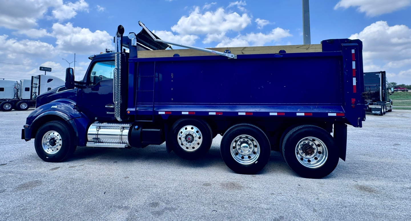 Kenworth T880 dump truck in blue profile view with dump bed and dual rear axles.