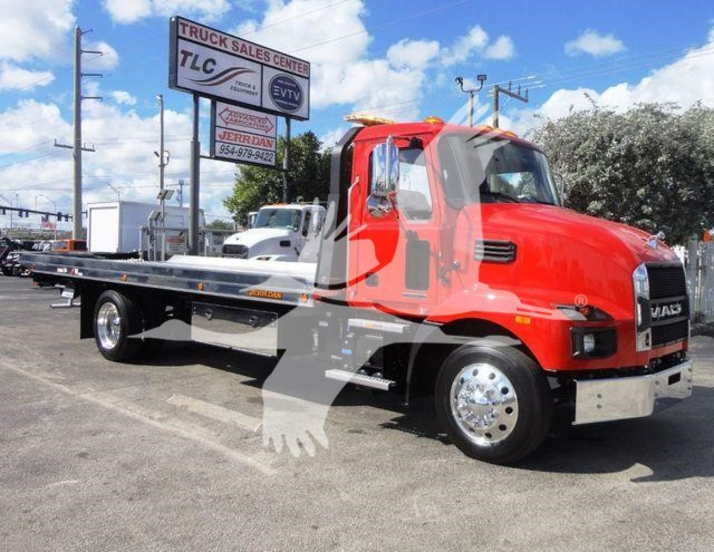 New 2027 Mack MD6 rollback tow truck in red cab and flatbed, side view showing chrome wheels and dealership lot.