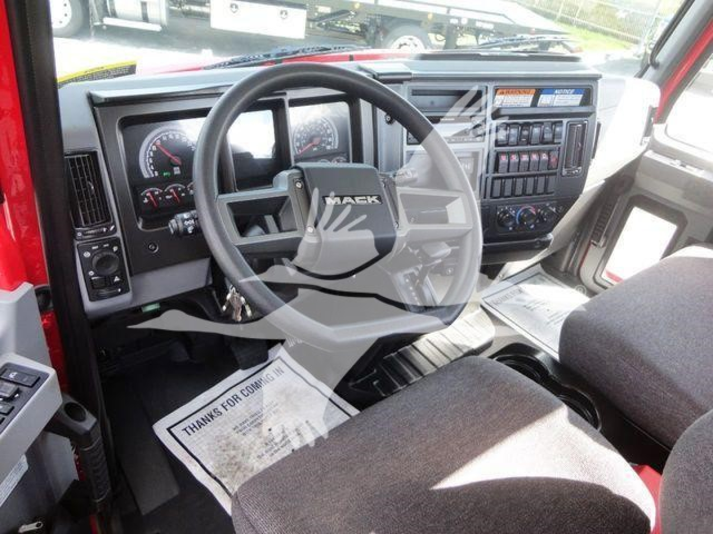 Mack Md6 truck interior showing steering wheel, dashboard, gauges, and control panel.