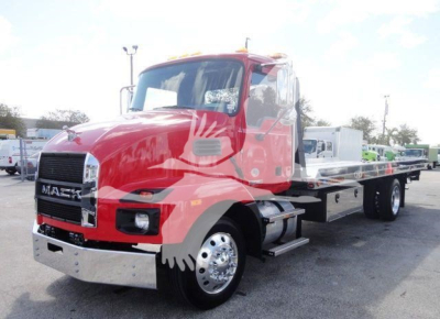 Red Mack MD6 tow truck/rollback in a parking lot with chrome bumper; cab shows "MACK" grille; stock number J04541 in listing; no visible reservoir labels readable.
