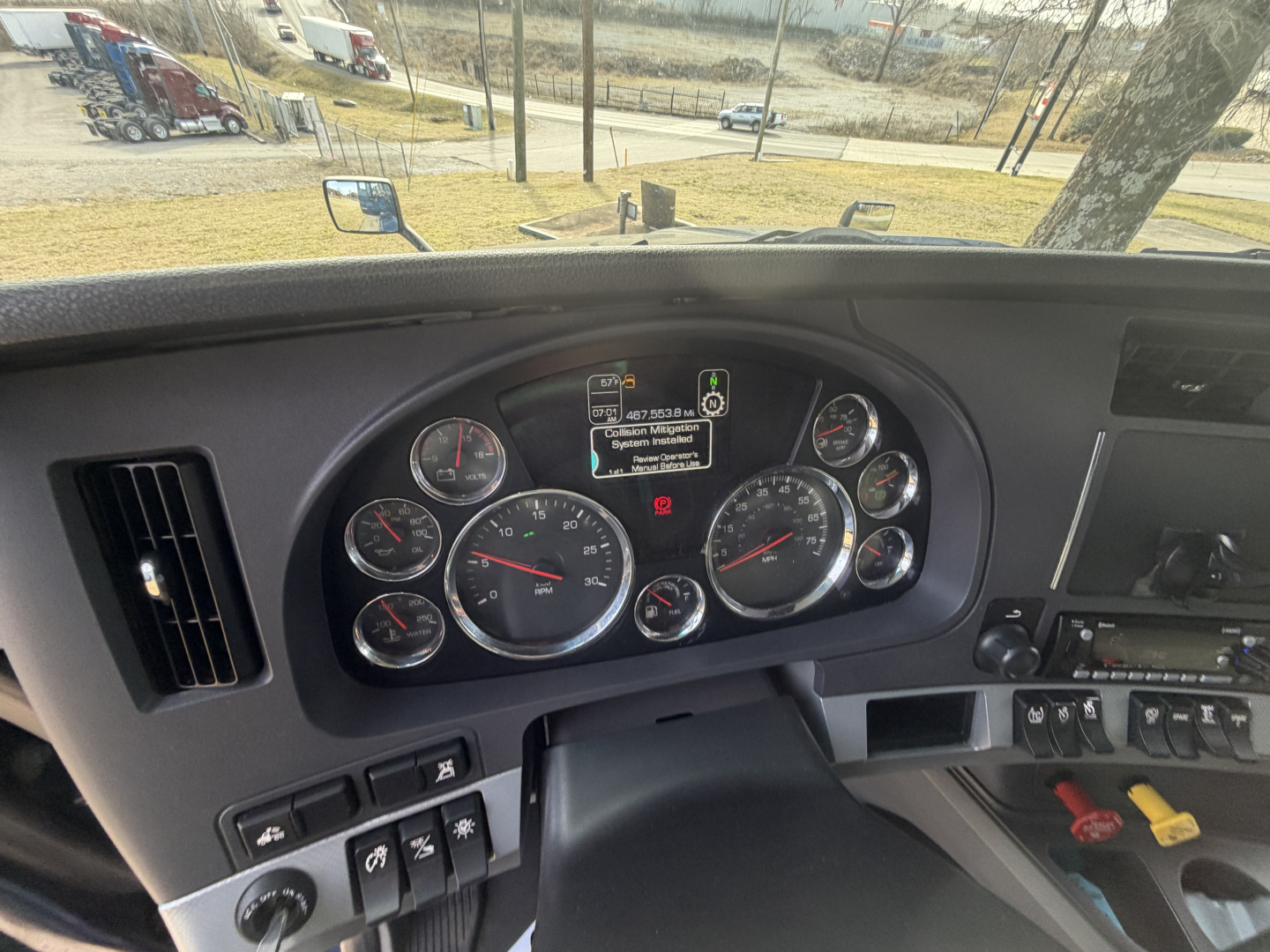 Dashboard of a 2020 Kenworth T680 truck showing multiple gauges, warning lights, and central display screen.
