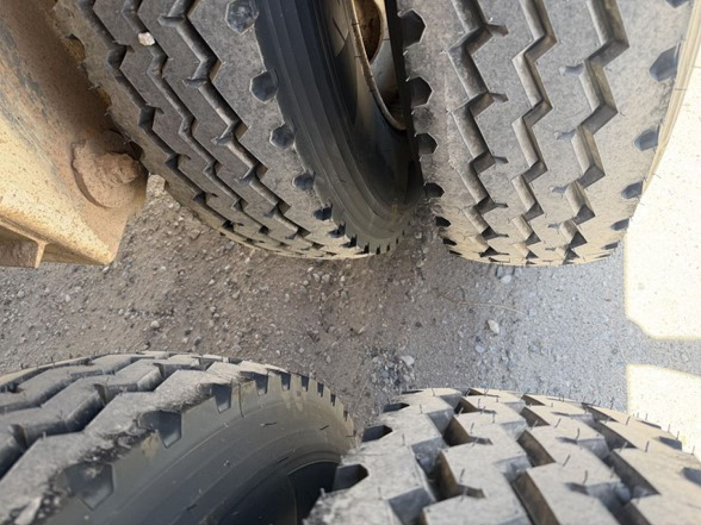 Dump trailer wheels and tires close-up view showing dual axle arrangement and tread pattern.