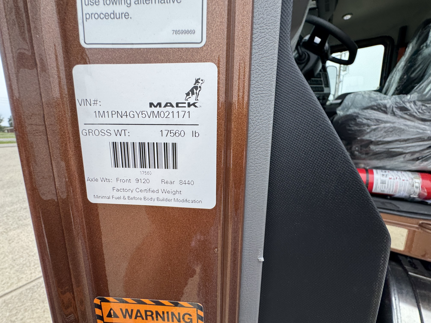 Mack PI64T truck cab door sticker with VIN 1M1PN4GY5VM021171 and gross weight 17560 lb, and a Mack logo visible.