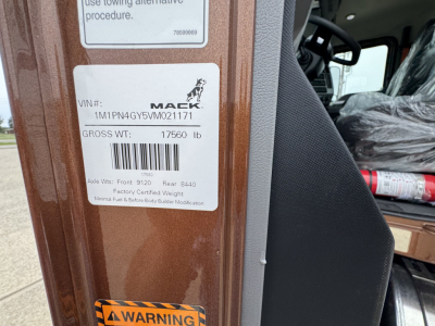 Mack PI64T truck cab door sticker with VIN 1M1PN4GY5VM021171 and gross weight 17560 lb, and a Mack logo visible.