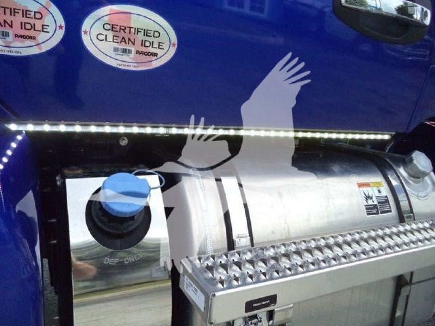 Kenworth T280 truck side view showing a cylindrical fuel tank with blue filler cap, diamond-plate side step, and a row of LED clearance lights above.