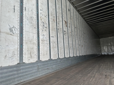 Interior of a 2016 Utility 4000DX trailer showing metal side walls, wooden floor, and cargo area.