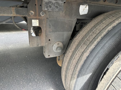 Trailer hitch area of a 2016 Utility 4000Dx trailer showing the frame, suspension hanger, and dual rear tires with visible wear marks.