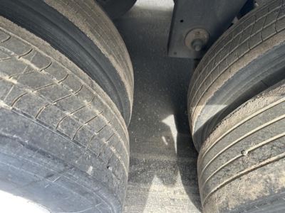 Dual rear trailer tires on a Utility 4000Dx trailer, tread visible with some wear and dirt on the tire surfaces.
