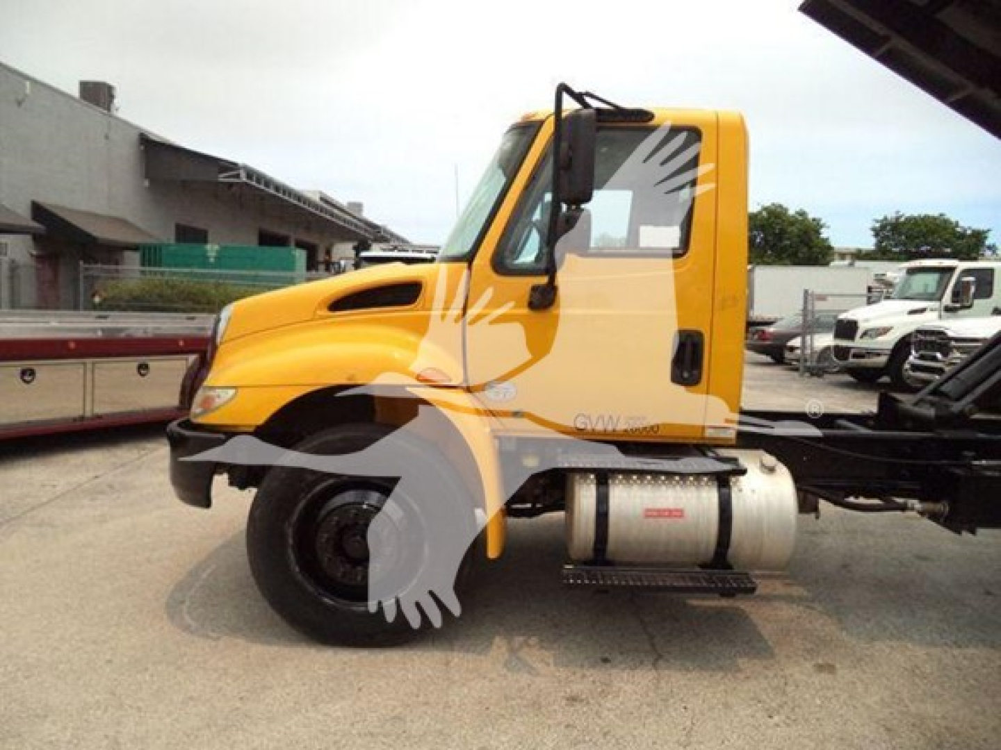 Truck cab of a 2019 International Durastar 4300 in side view with yellow cab and diesel fuel tank visible.
