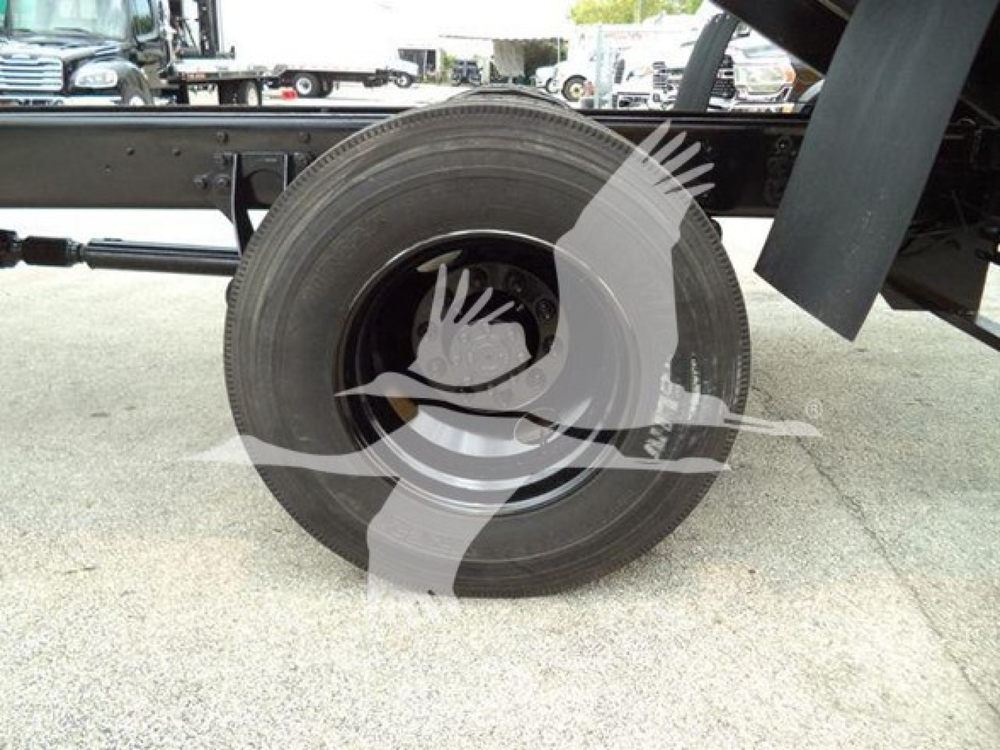 Dump truck wheel and undercarriage view showing spare tire mounted on frame of 2019 International Durastar 4300