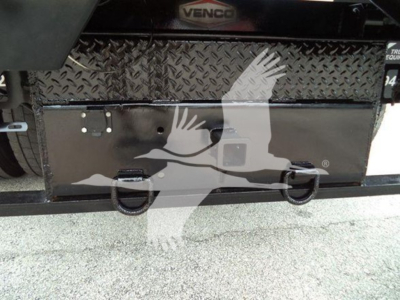 Truck rear bumper area of a 2019 International Durastar 4300 showing a black diamond-plate toolbox with two latching handles and VIN/stock area nearby.