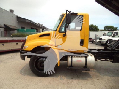 Truck cab of a 2019 International Durastar 4300 in side view with yellow cab and diesel fuel tank visible.
