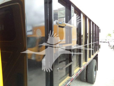 Dump truck side view showing black dump body and wheels.