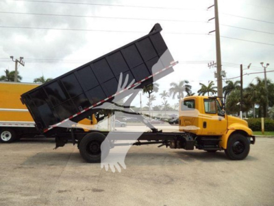 Vehicle side view of a yellow 2019 International Durastar 4300 dump truck with its bed raised, showing the cab and hydraulic mechanism.