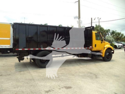 2019 International Durastar 4300 dump truck side view with yellow cab and black dump body, stock number and VIN not visible on the body.