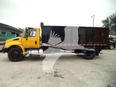 Dump truck: 2019 International Durastar 4300 with yellow cab and black dump body. Side view showing VIN or stock not legible. No readable text visible on vehicle components.