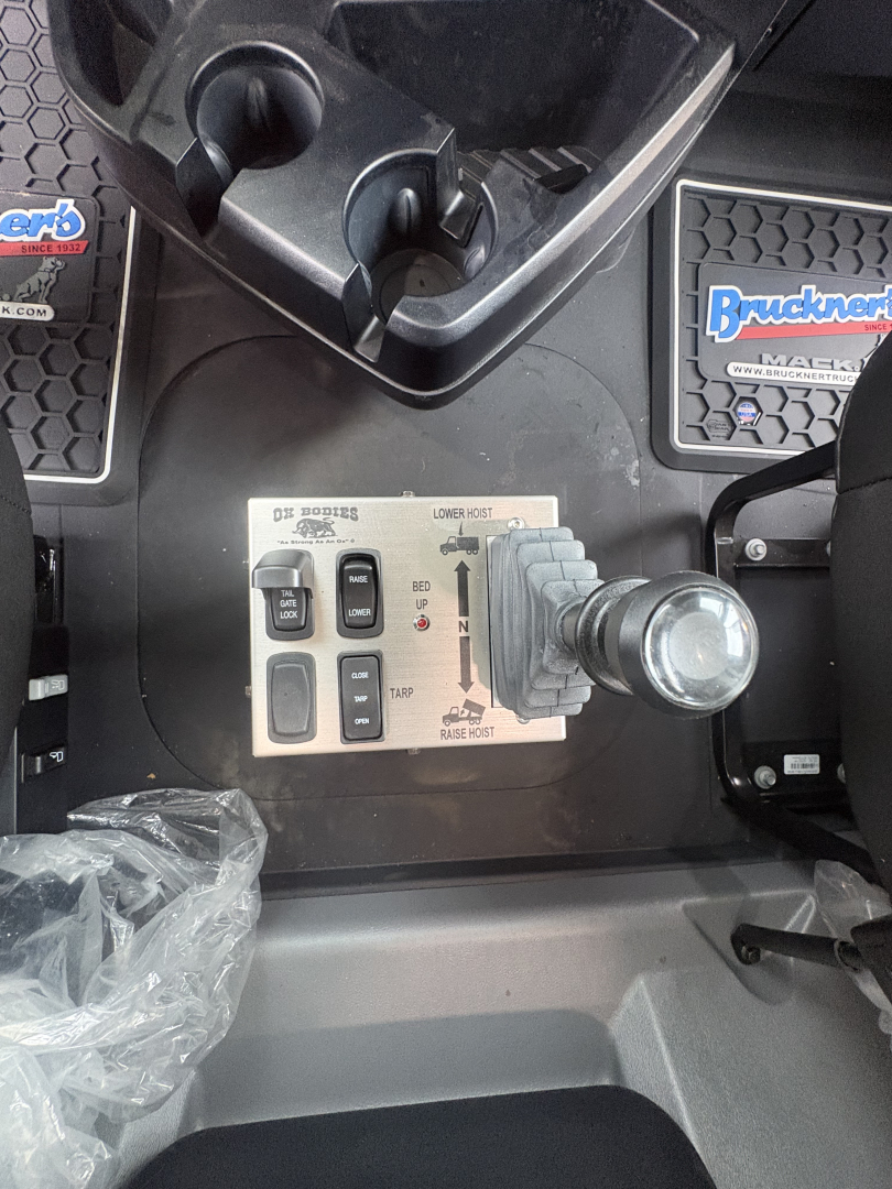 Mack GR84F truck interior control panel with joystick lever and multiple switches visible in the cab area.