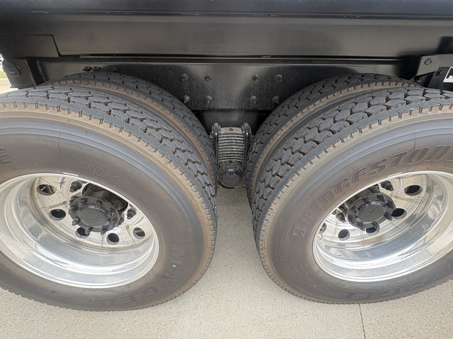 Dual rear wheels with heavy-duty suspension and leaf springs visible under chassis.