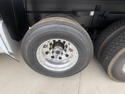 Mack heavy truck wheel and tire showing Bridgestone tire brand and polished aluminum rim.