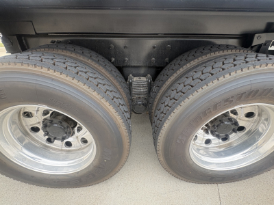 Dual rear wheels with heavy-duty suspension and leaf springs visible under chassis.