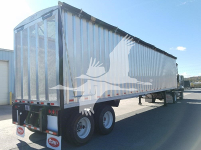 Trailer side view showing a Dorsey Open Top Chip Van with metal sided hopper, dual rear wheels, and reflective striping.