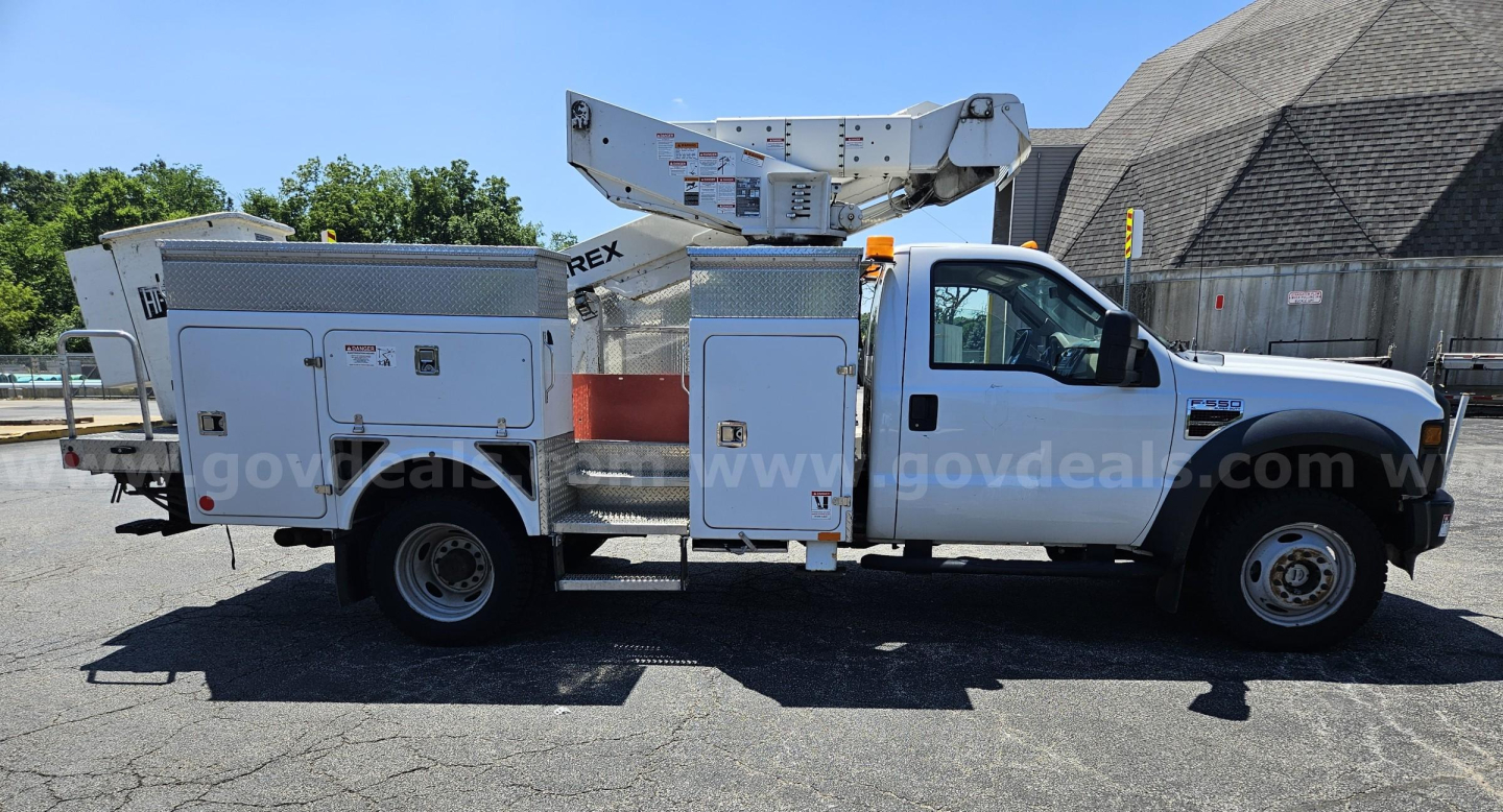 Ford F-550 service/utility truck with utility bed and bucket lift, side compartments visible.