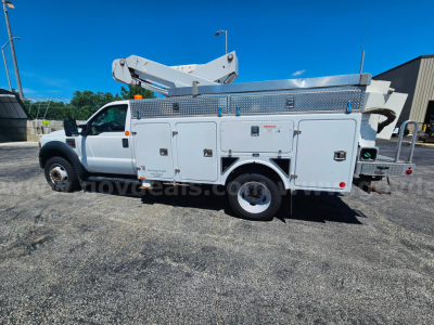Ford F-550 service utility truck with bucket lift and multiple storage compartments, side view showing metal utility boxes and crane arm.