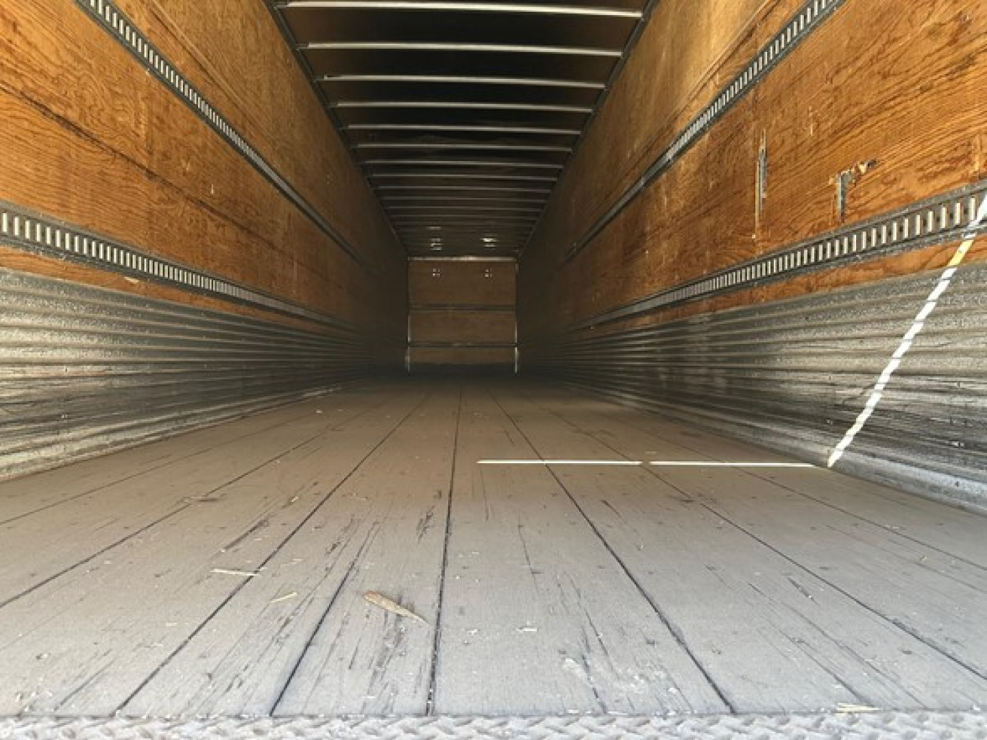 Trailer interior showing wooden side walls and steel floor of a 2015 Hyundai air ride dry van cargo area.