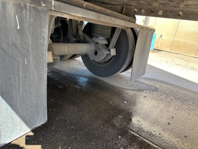 Trailer axle area showing rear suspension and wheel with mudflap under the 2015 Hyundai air ride dry van.